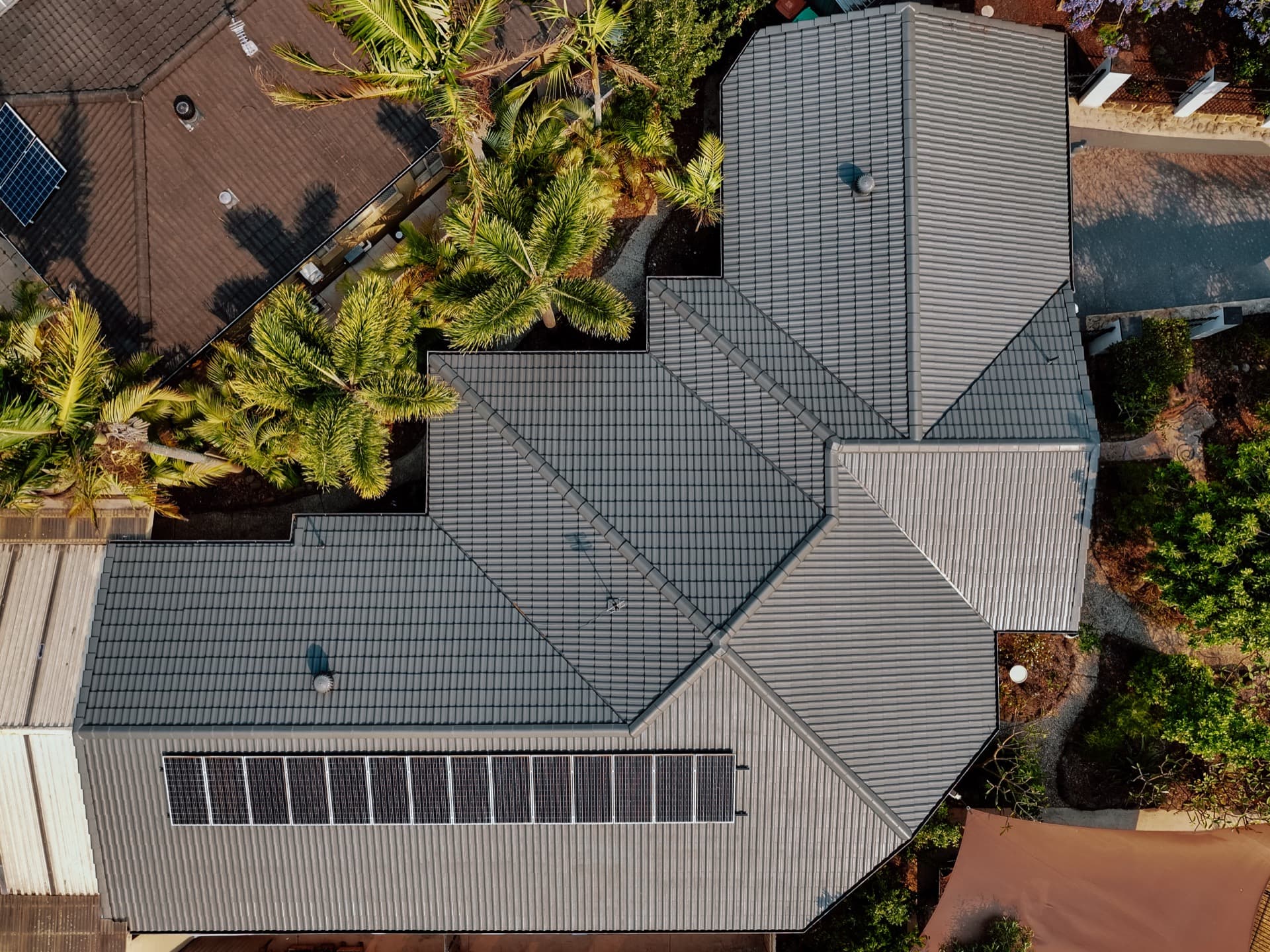 Professional roof restoration on Gold Coast home - aerial drone view of completed tile roof
